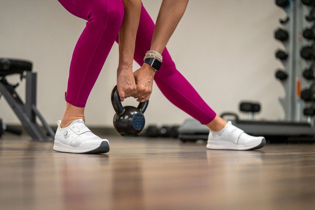 Women getting a weights workout in while wearing her white IC300 Shimano Indoor Cycling Shoes